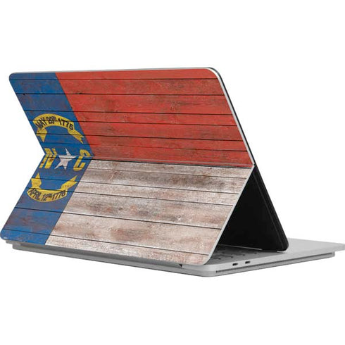 North Carolina Flag Dark Wood Surface Laptop Studio Skin