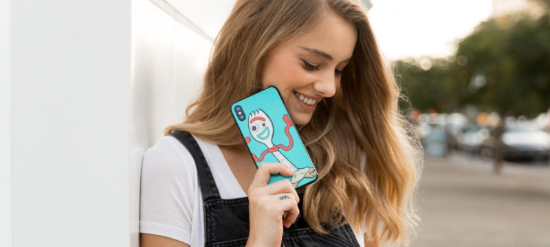 A woman holding up a custom iPhone skin
