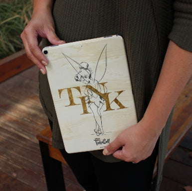 Person holding a tablet device with a custom Tinkerbell Disney character skin