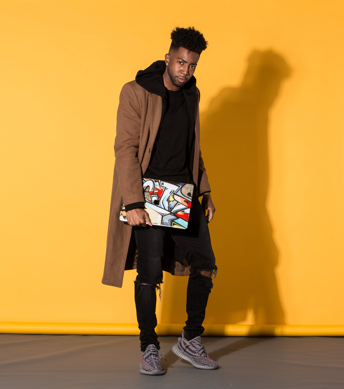 A man holding a laptop with a custom skin