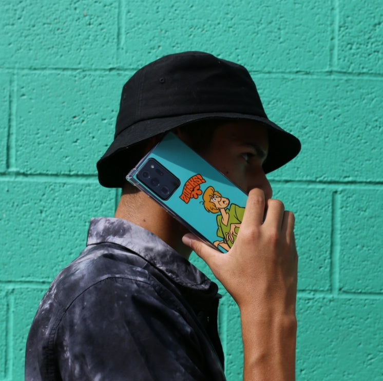 Man holding a phone with a custom Scooby Doo case